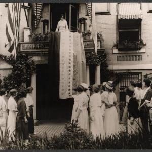 New suffrage hangs Alice Paul flag. Courtesy of filmmaker Barbara Cray