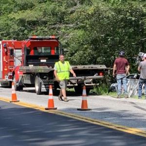 Hawke Motors’ wrecker gets into position to pull the bucket truck out of the embankment and back onto the road. KEVIN BURNHAM/Boothbay Register