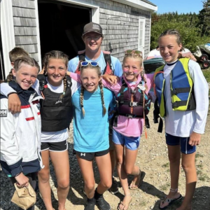 Southport Opti sailors, from left, Hadden Brinegar, Brooks Baker, Mabel Kaler, Lucy Browne, Addie Lambert with Coach Nate Rideout. Photo courtesy of Maddie Kaler
