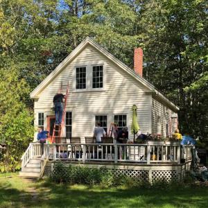 A Rebuilding Together crew paints a house during a past project. Courtesy of Jack Herger