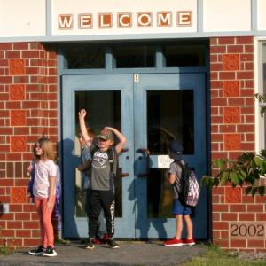 A student waves to a friend on the first day of school. FRITZ FREUDENBERGER/Boothbay Register