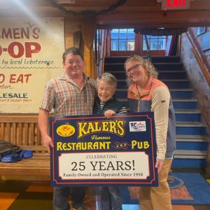 Sam, Mary and Maddie Kaler hold the sign recognizing Kaler’s Restaurant’s 25 years in business in Boothbay Harbor. Courtesy photo
