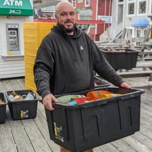 Eric Gimbel enjoys constructing the buoy tree community event at pier one Nov. 4. CANDI JONETH/Boothbay Register