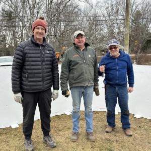 Charlie Britton, Matt Thibault and Bucky Holloway pause in their rink assembly work on Christmas Eve. JENNY BENNETT/Boothbay Register