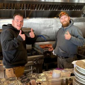 Nick Christopher, left, and Riley Mitchell helping out on the grill. Jennie Mitchell photo