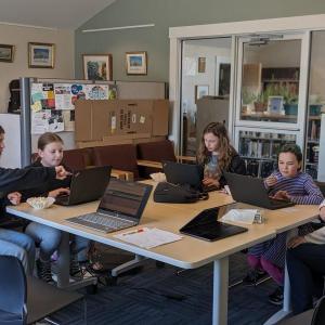 Girls Who Code, from left, Camille Ross, facilitator; Jacqueline Branch, coding a Travis Kelce-Taylor Swift Pong game; Emma Scott, coding a basketball game; Kinsley Weiss, coding a choose-your-own-adventure story; and Bethany Schmidt, facilitator. CANDI JONETH/Boothbay Register