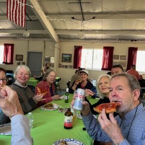 Enjoying pizza and beverages after the island clean-up. Courtesy of Louise Cowan