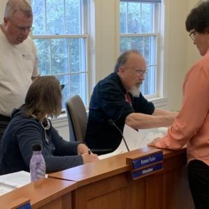 Lisa Burnham, right, assists the Boothbay Planning Board May 15 in reviewing maps related to her request for a change of use. BILL PEARSON/Boothbay Register