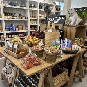 The new grocery table where such goods as SGS crostini and artisan baguettes are to be found alongside the fresh fruit and vegetables. The bulldog has pride of place in honor of the late Mike Beane, friend to all and long-term employee at the General Store. JENNY BENNETT/Boothbay Register