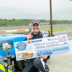 Kevin Douglass celebrates his Shipbuilders 100 victory with a $3,000 check. Jasen Dickey Photography