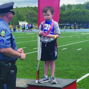Jameson Brooks receives a medal at a Special Olympics Maine event. Courtesy photo
