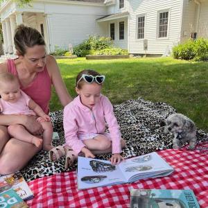 Devon, Zoe and Kenzie Brewer share a story with Murphy. Courtesy of BHML
