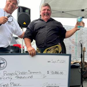 Tuna Challenge committee member Andrew Morley, left, presents Roger Simmons awards for winning the 2024 Boothbay Harbor Tuna Challenge. Simmons won the tournament alongside his son, Shelden. Courtesy of Boothbay Harbor Tuna Challenge