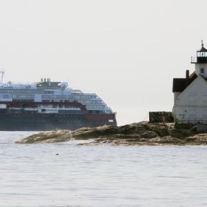 Roald Amundsen passes behind Cuckolds Lighthouse on its way into Boothbay Harbor. STEVE EDWARDS/Boothbay Register The ship Roald Amundsen and Cuckolds Lighthouse