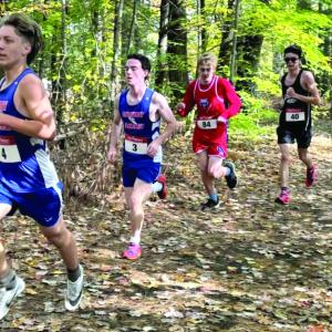 A BOYS PACK RUNS through the woods at the MVC championships Oct. 19. Courtesy of Josiah Winchenbach Boy runners