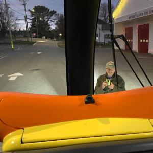 A man taking pictures of the Wienermobile