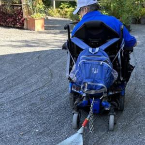 Man raking with wheelchair