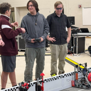 Silas Lehouillier and Afton Warren-Burdin discuss strategy with an alliance partner before beginning a match. Courtesy photo
