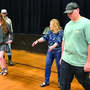 In Stover Auditorium during marching practice May 31, Debra Pooler shows seniors where to be. SUSAN JOHNS/Wiscasset Newspaper 