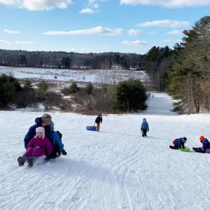 Sledding action on the big hill at Salt Bay Farm during a Coastal Rivers sledding party.  Courtesy photo
