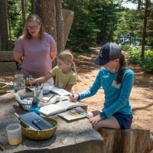 Children work with watercolor paints during a summer camp. Courtesy of CMBG