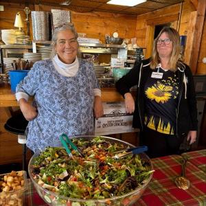 Chef Amy Ronan, left, and helper Shirley from St. Andrews Village serve the food at Community Lunch. Jen Mitchell photo