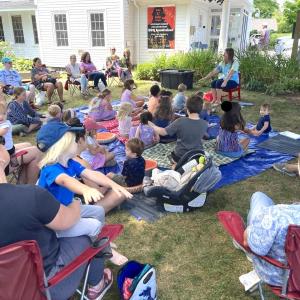 Children's Coordinator Jen Betts leads a summer storytime on BHML's lawn. Courtesy of Boothbay Harbor Memorial Library.