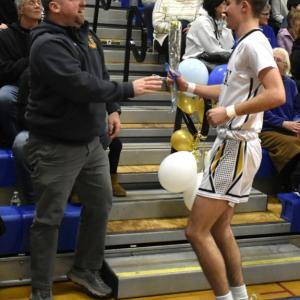Aidric Canada presents his carnation to his father, Kyle Canada. BOOTHBAY REGISTER/Fritz Freudenberger