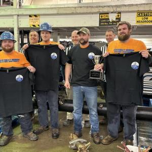 The "Mud Dogs," consisting of Gage Seavey, Cody Brown, Weston Alley and Shawn Simmons, take home the trophy at annual pipe tapping competition. Courtesy of the Boothbay Region Water District