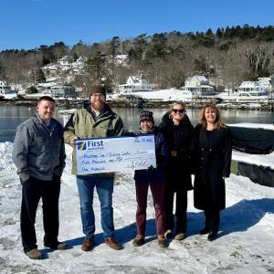 From L: First National Bank’s Dan Hallinan and Adam Climo, Boothbay Sea and Science Center’s Pauline Dion, First National Bank’s Alyssa Allen and Nicci Kimball presenting a check for $5,000 toward rebuilding the pier project. Courtesy of First National Bank