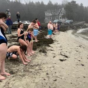 Leprechaun Leap participants line up to run into the ocean. Courtesy of Toby LeConte
