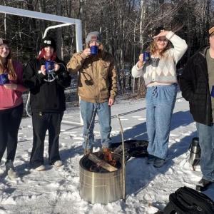 Lincoln Academy students enjoy the hot cocoa they prepared after building a fire. Courtesy of Shannon Parker