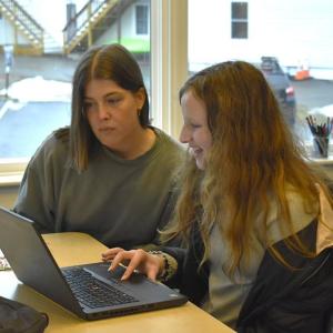 Club co-facilitator Camille Ross and Emma Scott review Scott's animation created using block-coding. ISABELLE CURTIS/Boothbay Register