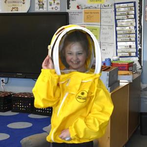  First grader Amelia Noyes shows off her bee-keeping gear, courtesy of Barter Island Bees. ISABELLE CURTIS/Boothbay Register