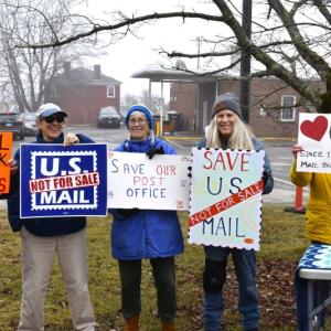 The weather may have been dreary but that didn't stop protestors from gathering to challenge the possible privatization of the USPS. ISABELLE CURTIS/Boothbay Register