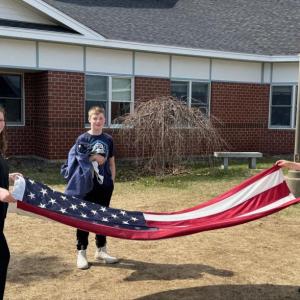 Edgecomb Eagles folding the flag are Isabel, daughter of Cashel and Brian Fanslau; Mason, son of Nicole McKay and Patrick Wenners; and Andrew, son of Amanda and Andy Main.  Students are residents of Alna and Edgecomb. Courtesy photo
