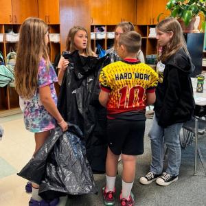 EES students discuss particular assignments on their recycled “paper route.”  Hattie, daughter of Nellie Brylewski and Simon Tomko;  Briar, daughter of Arianna and Brice Johnson;  Azalea, daughter of Laurel and Max Averill;  Bryson, son of Melissa and Joseph Hersom;  and Isabel, daughter of Cashel and Brian Fanslau.  Students are residents of Alna and Edgecomb. Courtesy photo