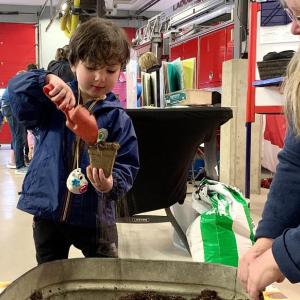 A young attendee pots flower seeds at Coastal Maine Botanical Gardens’ booth at Earth Day Fest. ISABELLE CURTIS/Boothbay Register