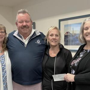 L- R: Angela Robinson, Director of Waiver Services, Mobius,  Mike and Sue Risinger, and Mobius Executive Director Michaela York, who accepted the donation on behalf of Mobius in memory of Kylee Risinger Turcotte. Courtesy of Eleanor Busby