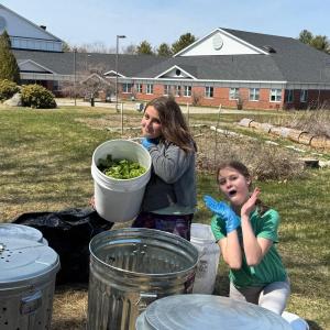 Sixth grade helpers Briar, daughter of Arianna and Brice Johnson, and Lilianna, daughter of Trista and Brian Cassidy, dump leftovers from Friday’s salad bar into the compost bins next to Edgecomb Eddy School gardens.  Students are residents of Alna and Edgecomb. Courtesy photo
