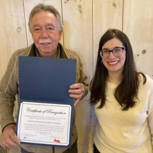 Bill Boynton, member of the Monhegan Broadband Committee and Emily Rabbe, Executive Director of LCRPC, displaying the award Monhegan's Broadband Committee received for their community planning efforts. Courtesy of LCRPC