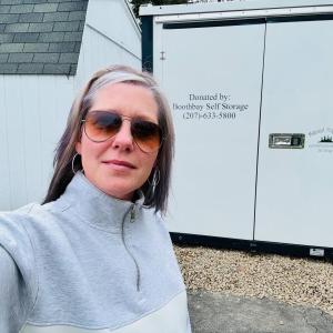 Linda Harriman, general manager of Midcoast Properties, with the storage unit the company donated to Legion Post 36. Courtesy of Linda Harriman