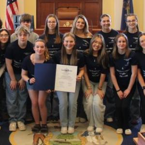 Sen. Cameron Reny, D-Bristol, left, and Rep. Holly Stover, D-Boothbay, right, stand with the Boothbay Region High School Drama Club and their legislative sentiment in the Senate chamber before session on April 29. Courtesy photo