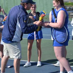 Seahawk coach Alex Arsenault presents flowers to senior Ivory Cody on senior day. KEVIN BURNHAM/Boothbay Register