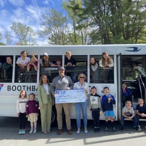 Representatives from First National Bank celebrate with members of the Y’s afterschool program, FitKids, directed by Lindsey Senecal, in first left hand window. FNB members, in front row, from left, are Lorna Weber, Adam Climo, and Alyssa Allen. Courtesy of Allyson Goodwin Y bus