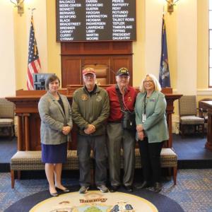 Sen. Cameron Reny, D-Bristol, left, and Rep. Holly Stover, D-Boothbay, right, stand with Phil Chapman and Jim Singer in the Senate Chamber before session on May 20. Courtesy photo