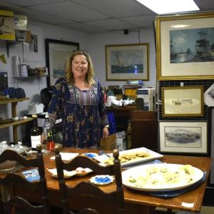 Laura de Haas of East Boothbay Trading Co., East Boothbay pauses for a "Kodak moment" during the June 6 First Friday.  LISA KRISTOFF/Boothbay Register