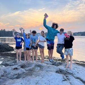 Jumping for joy at sunset. Courtesy of Hearty Roots