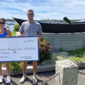 Tuna Challenge Chairman and Carousel Marina Manager Jax van der Veen and Dock & Facility Manager Evan Hepburn with last year's donation check. SARAH MORLEY/Boothbay Register