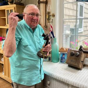 Howard Wright demonstrates an antique phone from Bug Lighthouse that he restored. FRITZ FREUDENBERGER/Boothbay Register